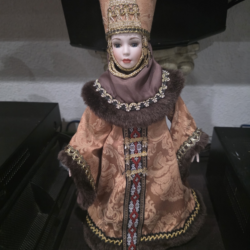 Ornate Brown and Gold Doll in Traditional Attire
